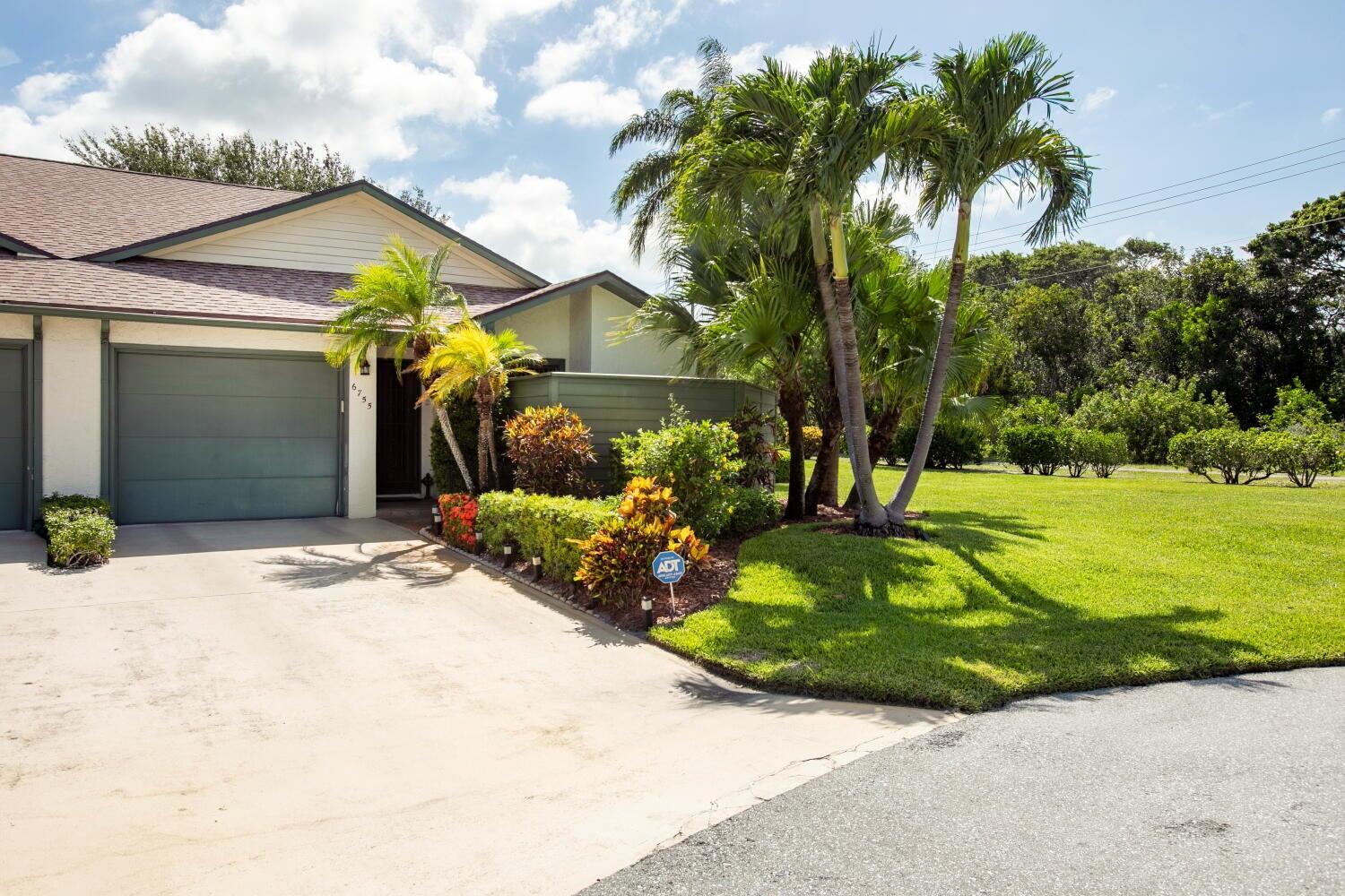 a view of a house with a yard and a garage