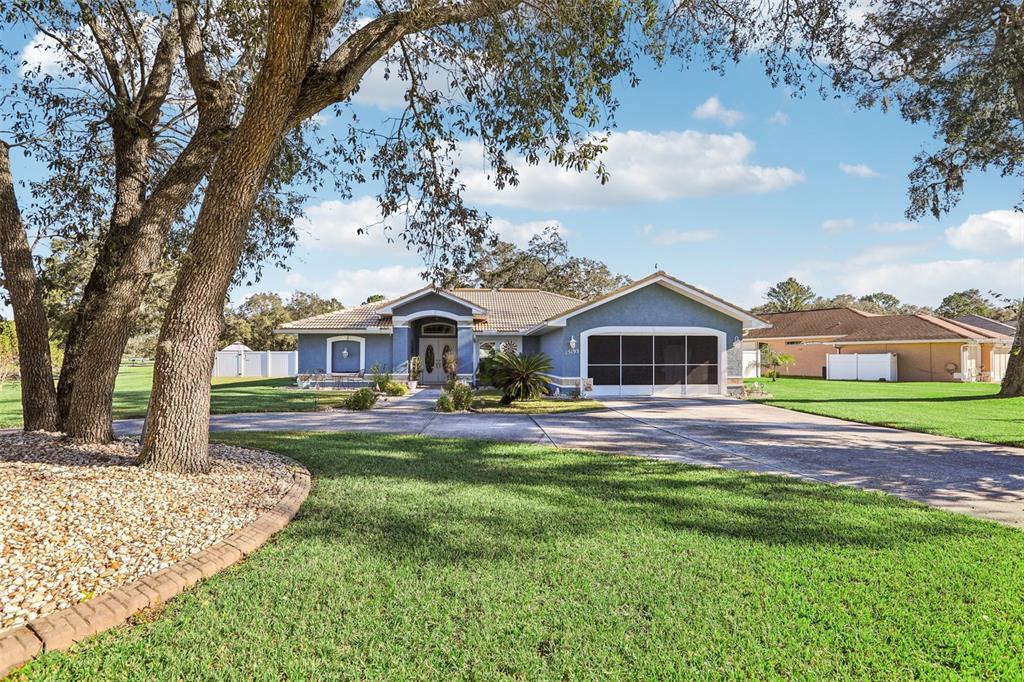 a front view of house with yard and green space