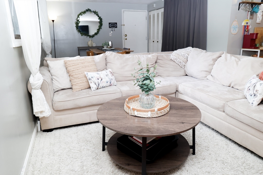 a living room with furniture and a mirror