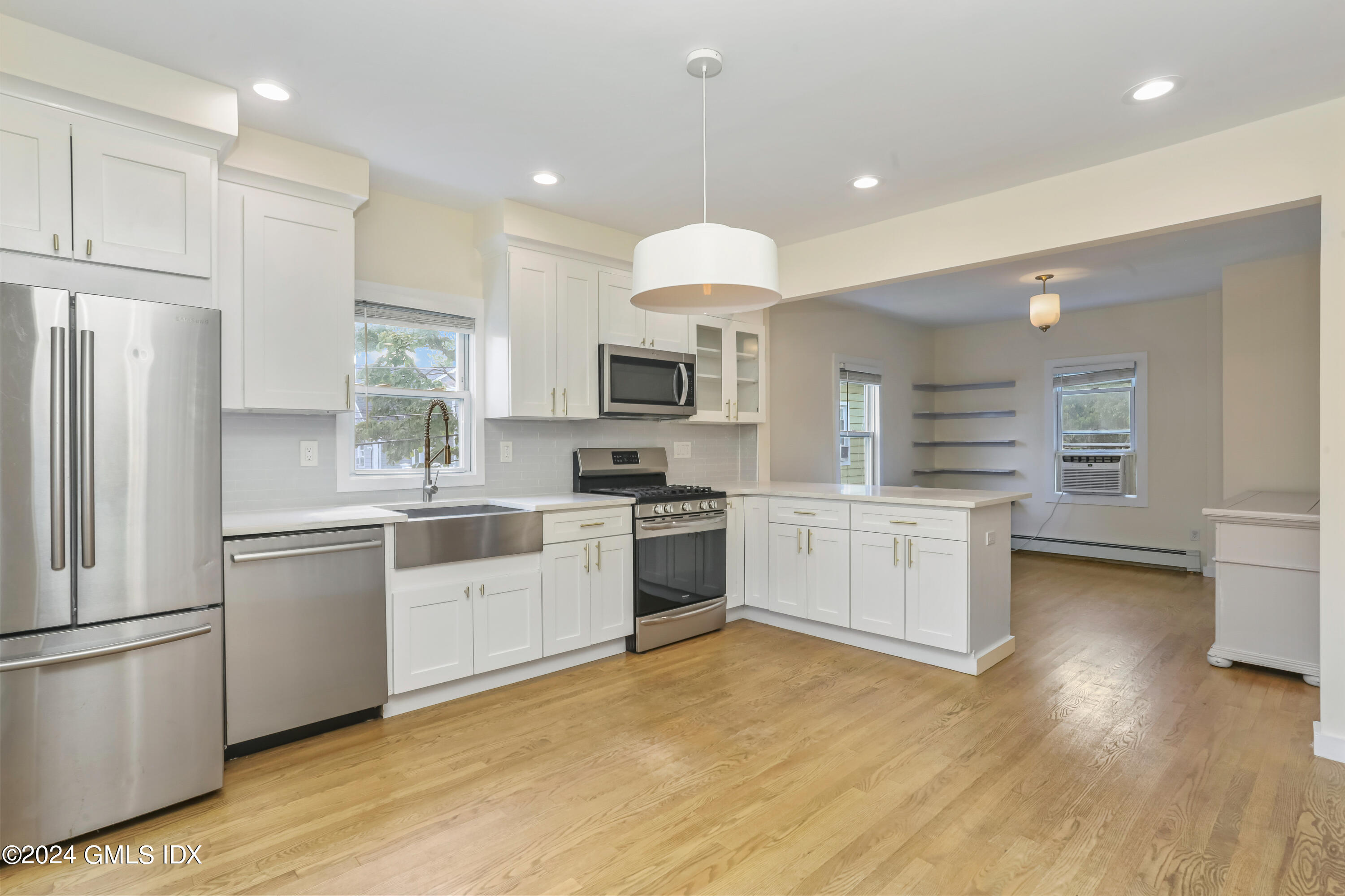 a kitchen with a white cabinets and white appliances