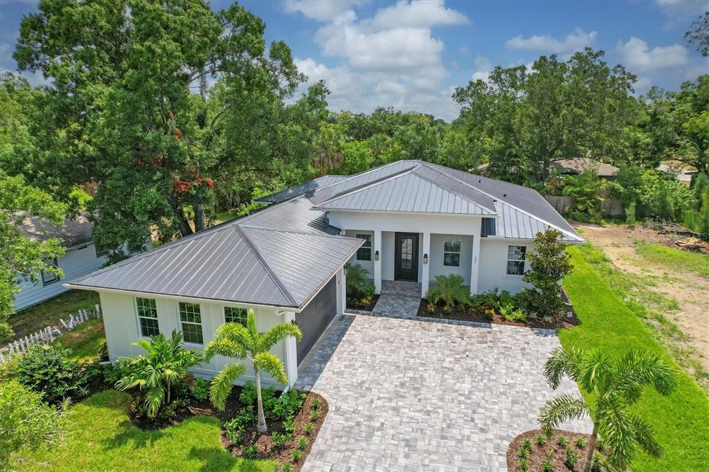 a aerial view of a house in the middle of a yard