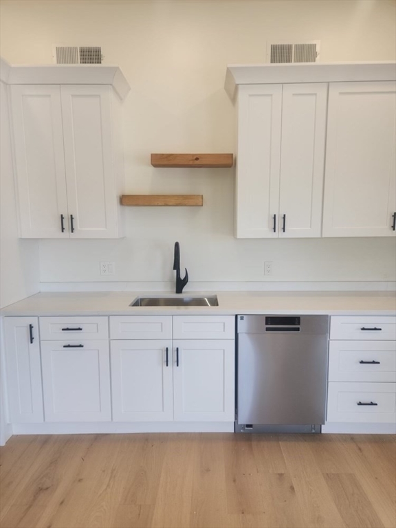 a kitchen with white cabinets and a sink