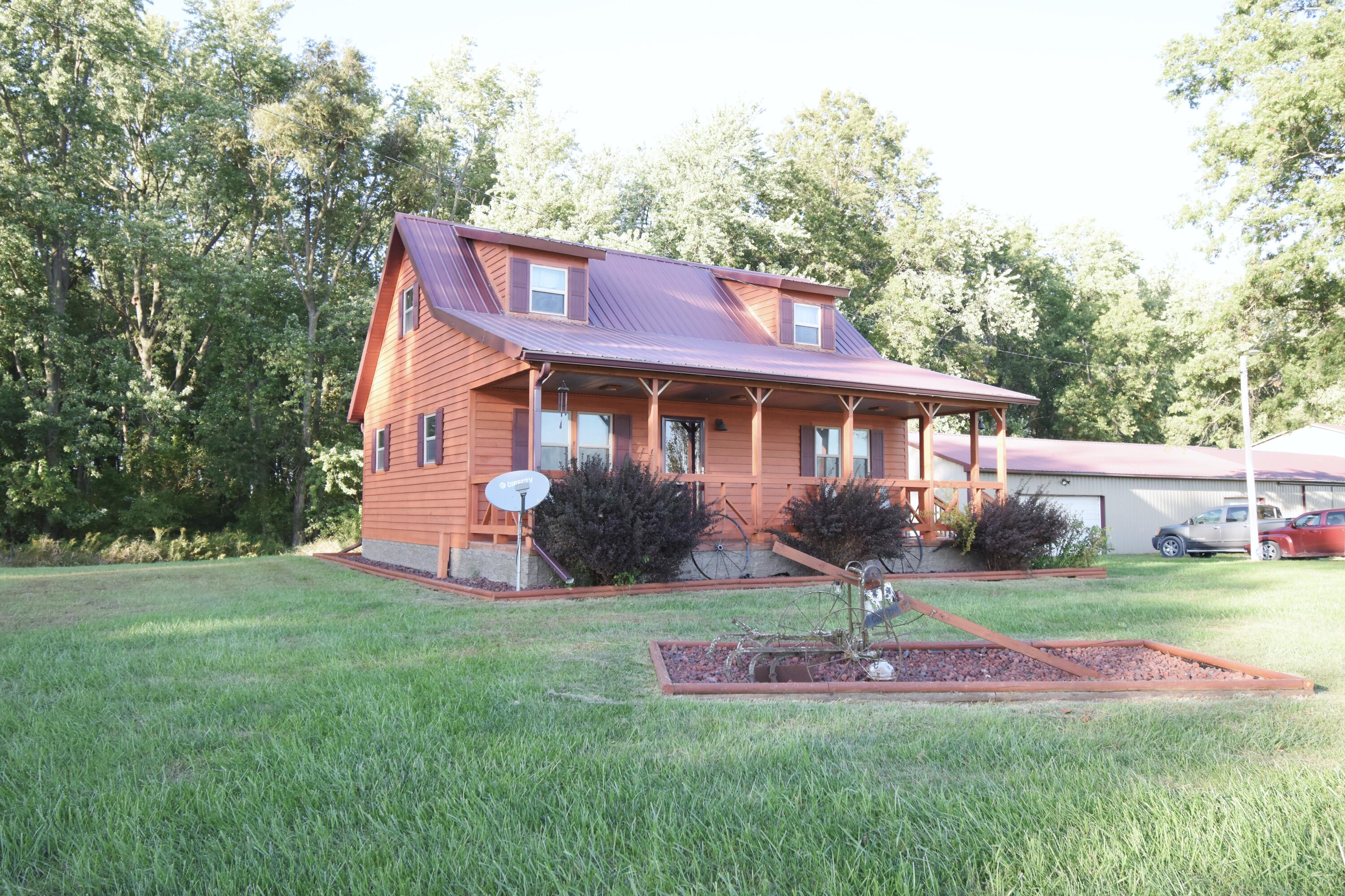 a front view of a house with a yard table and chairs