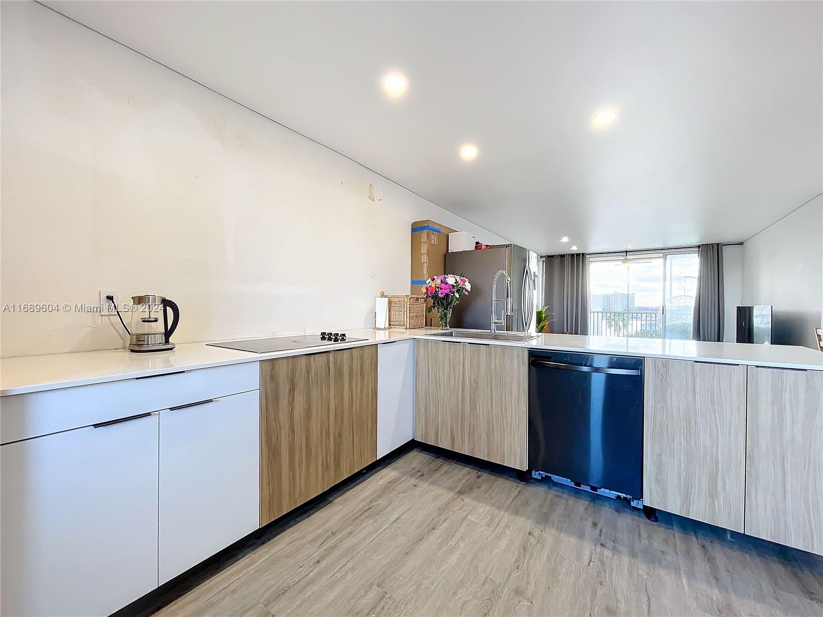 a kitchen with cabinets a sink and wooden floor