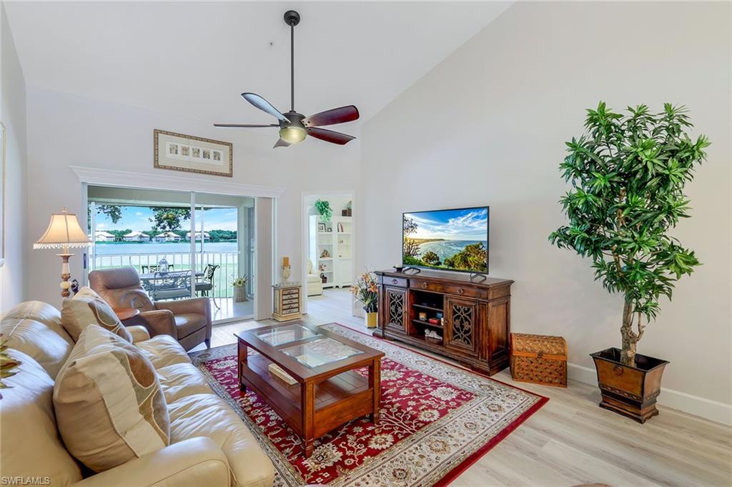 a living room with furniture a window and a flat screen tv