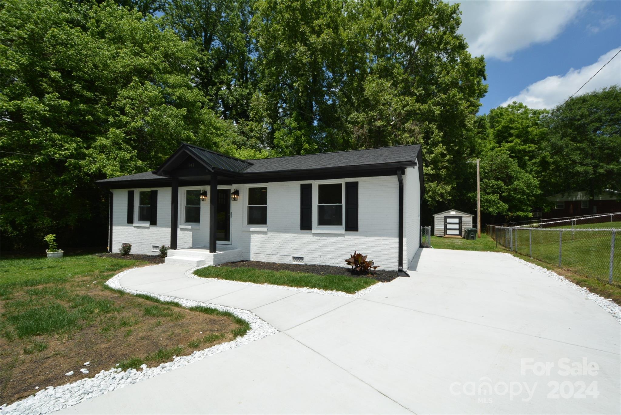 a front view of a house with a yard and porch