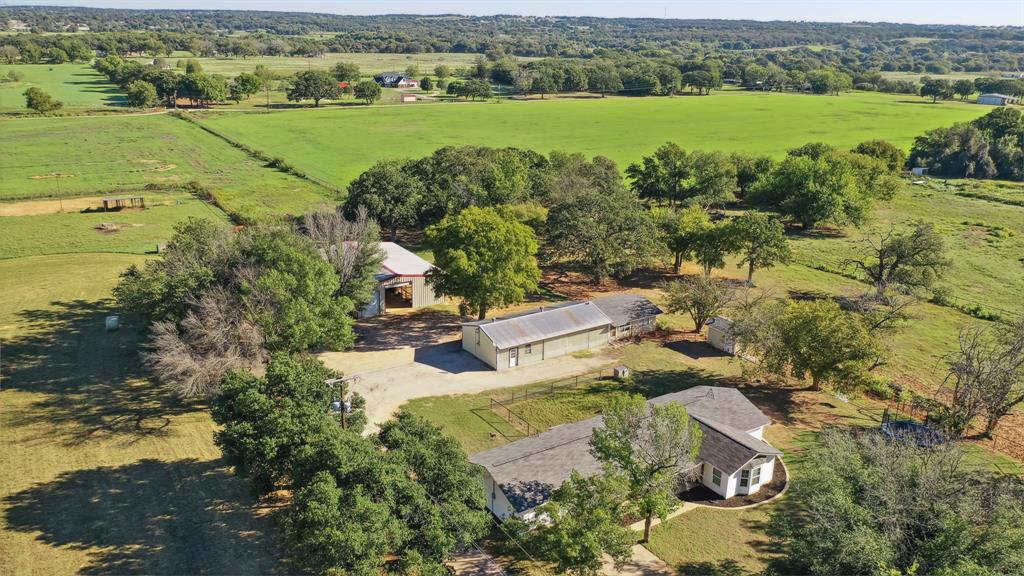 an aerial view of a house with a yard