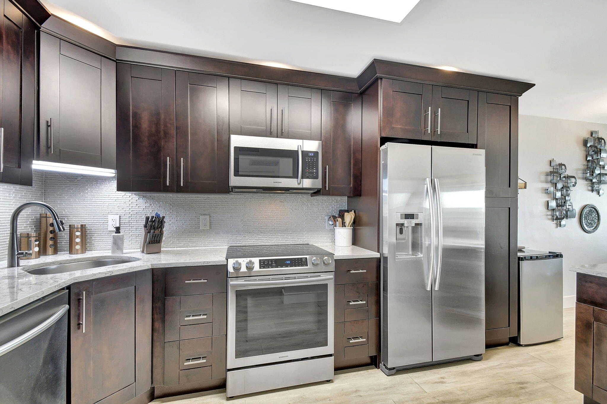 a kitchen with stainless steel appliances wooden cabinets and sink