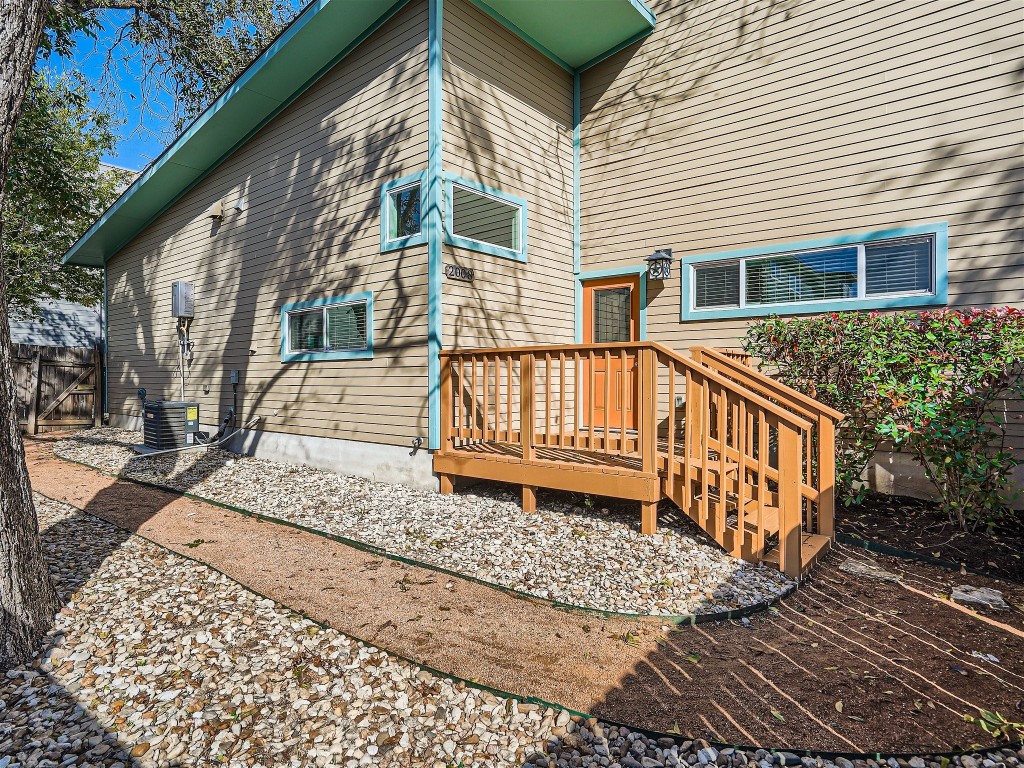 a view of a house with a wooden deck