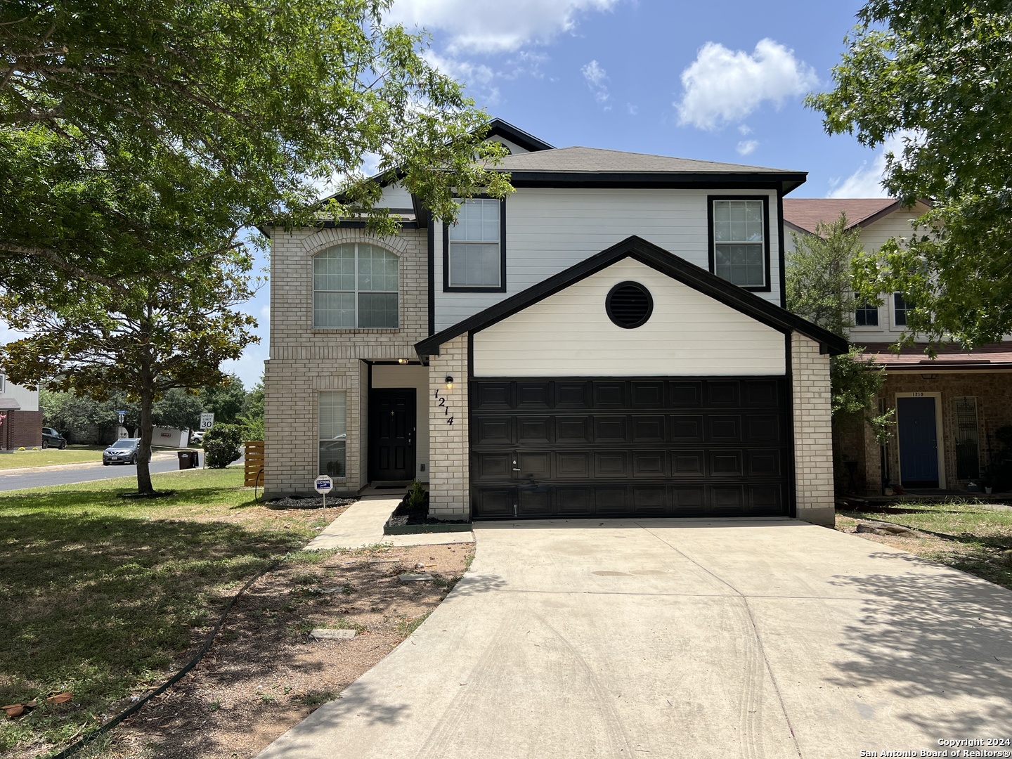 a front view of a house with a yard