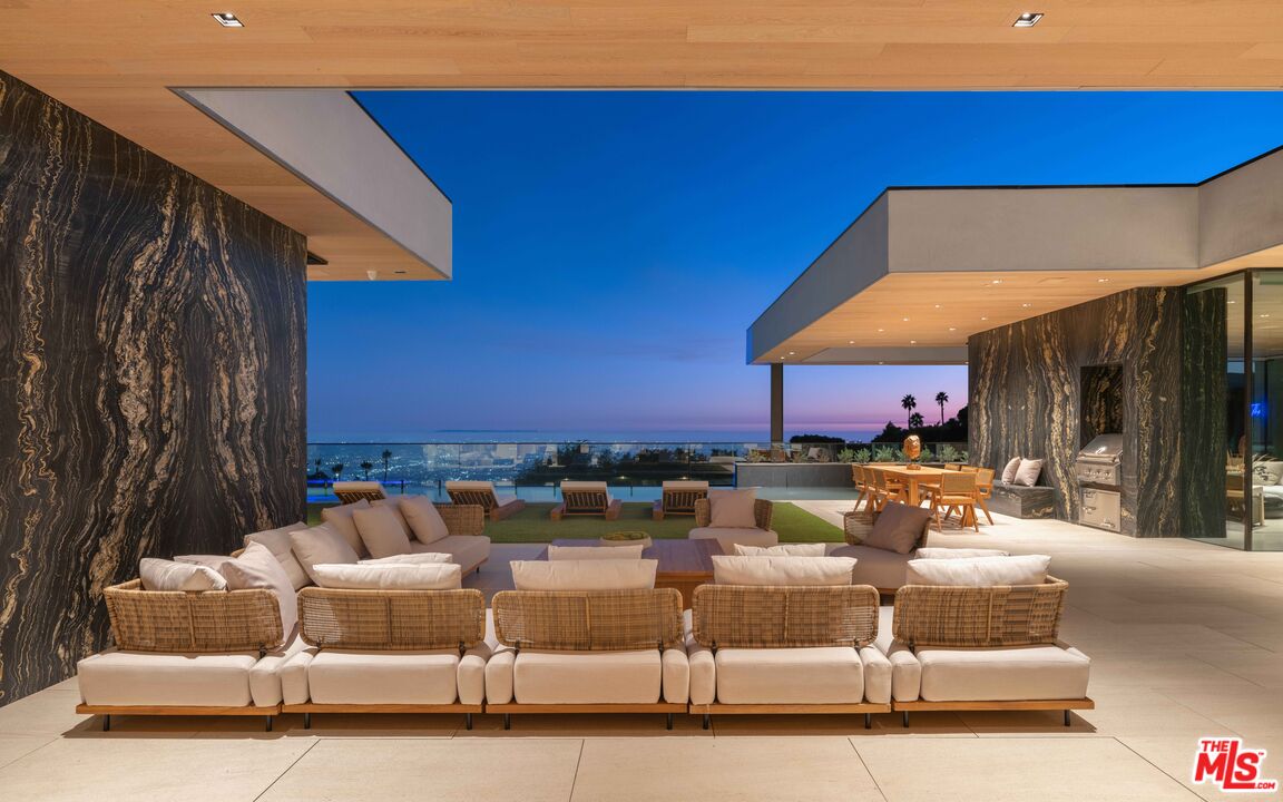 a view of a backyard with couches table and chairs