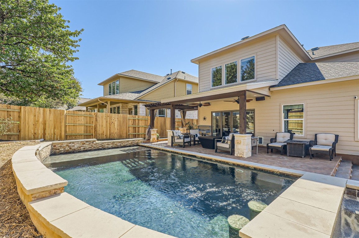 a view of a house with swimming pool and sitting area