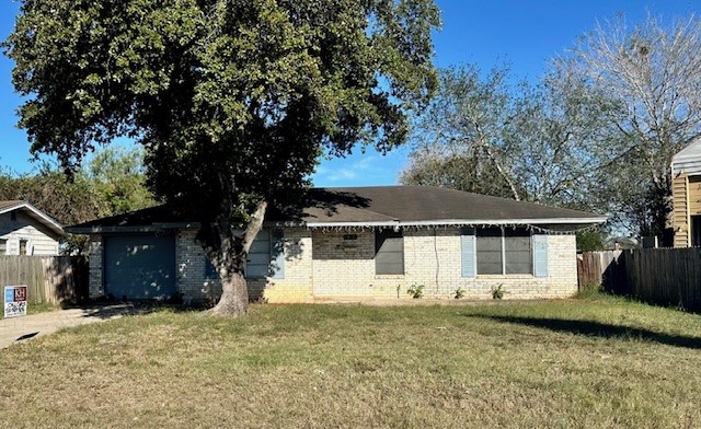 a front view of a house with a tree