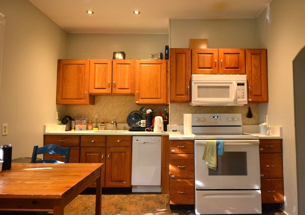 a kitchen with a stove a sink and cabinets