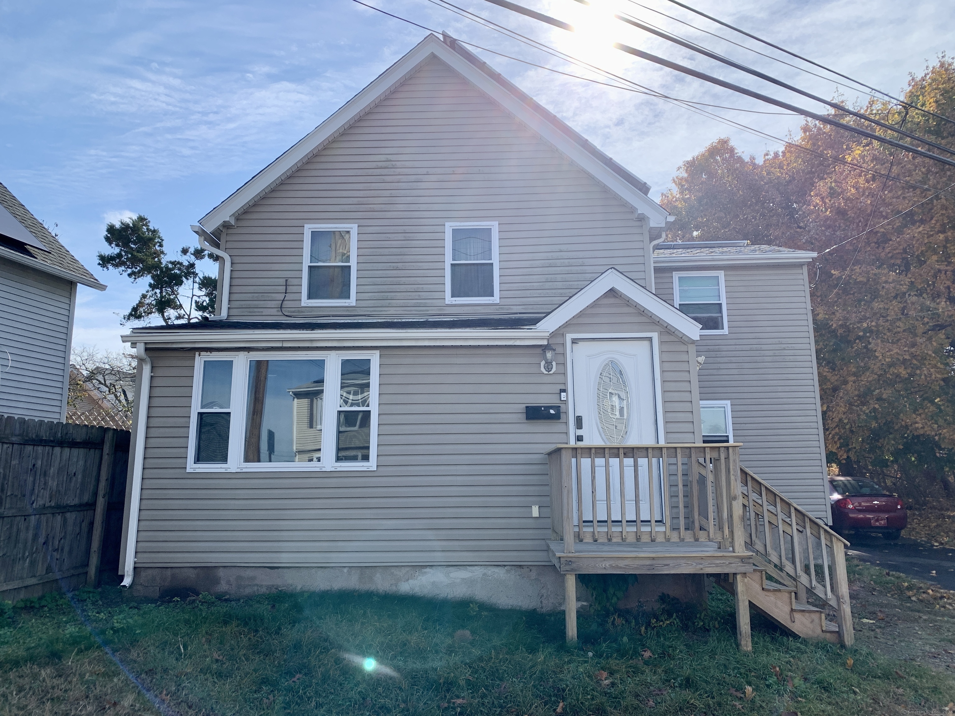 a view of a house with a yard and deck