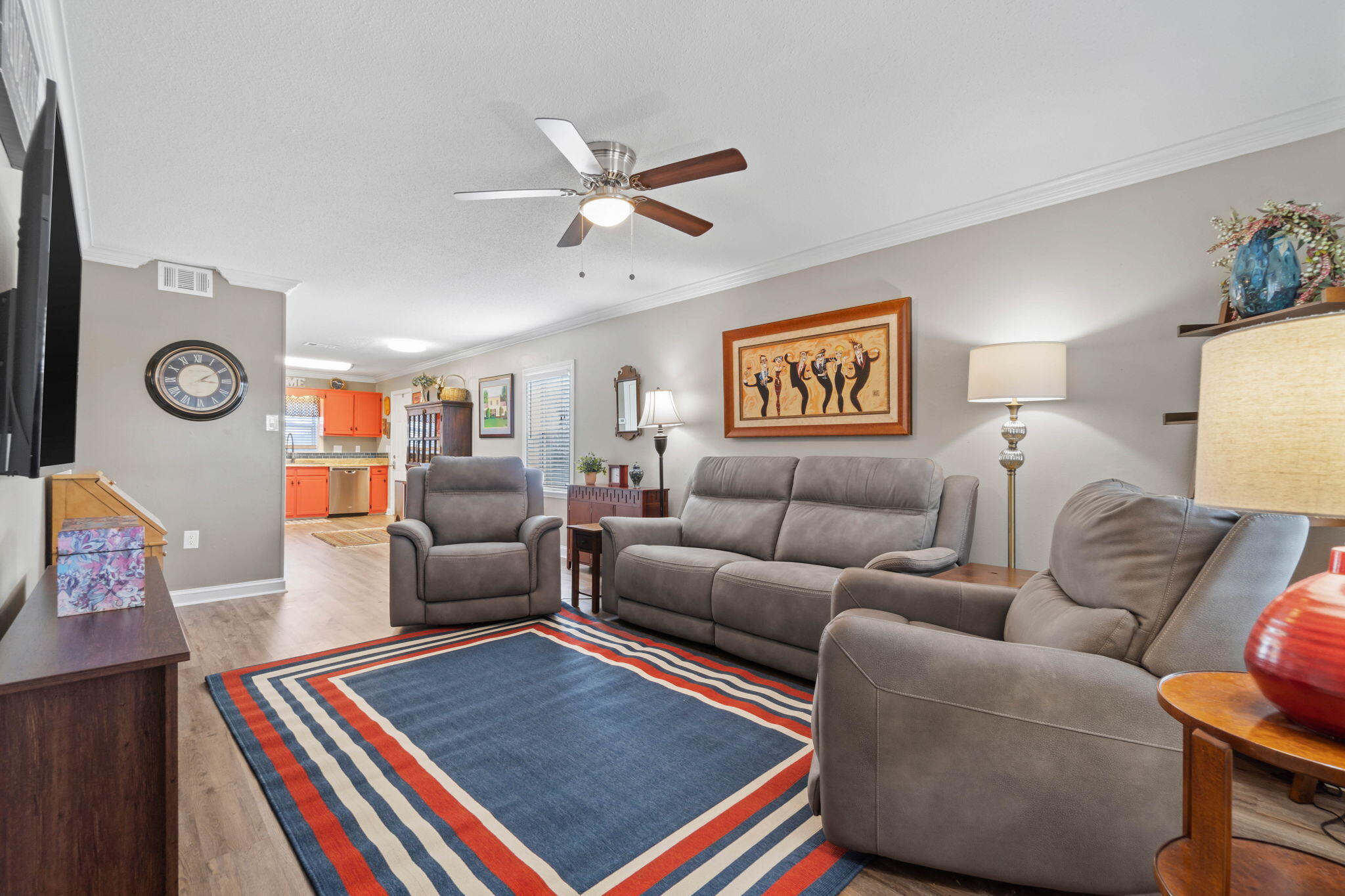 a living room with furniture and wooden floor