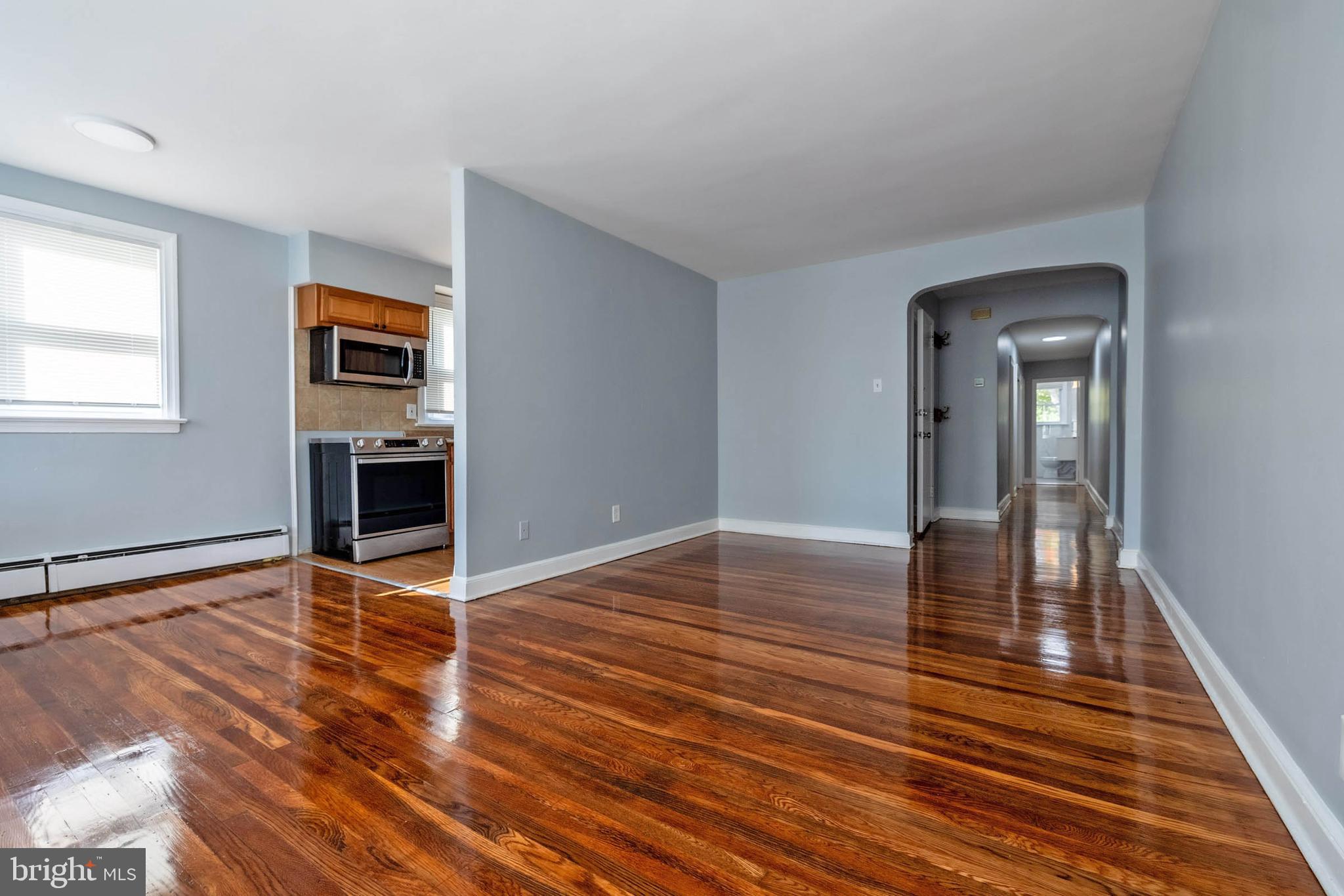 a view of empty room with wooden floor