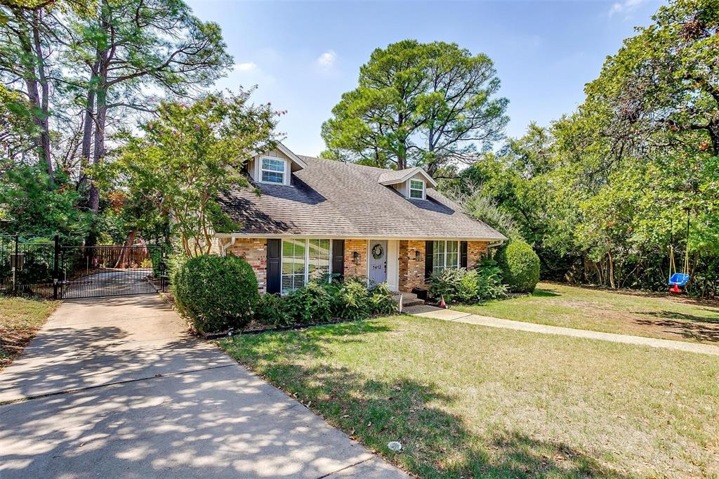 a front view of a house with yard and green space