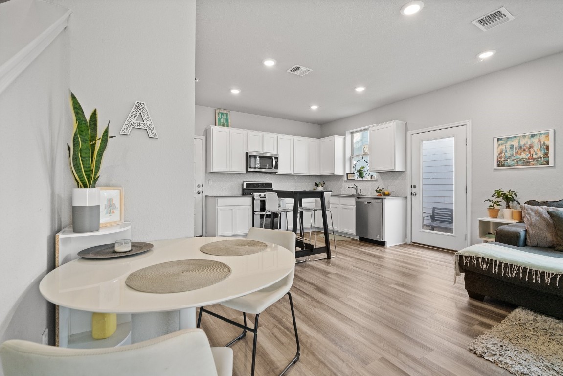 a kitchen with kitchen island a white counter top space a sink and appliances