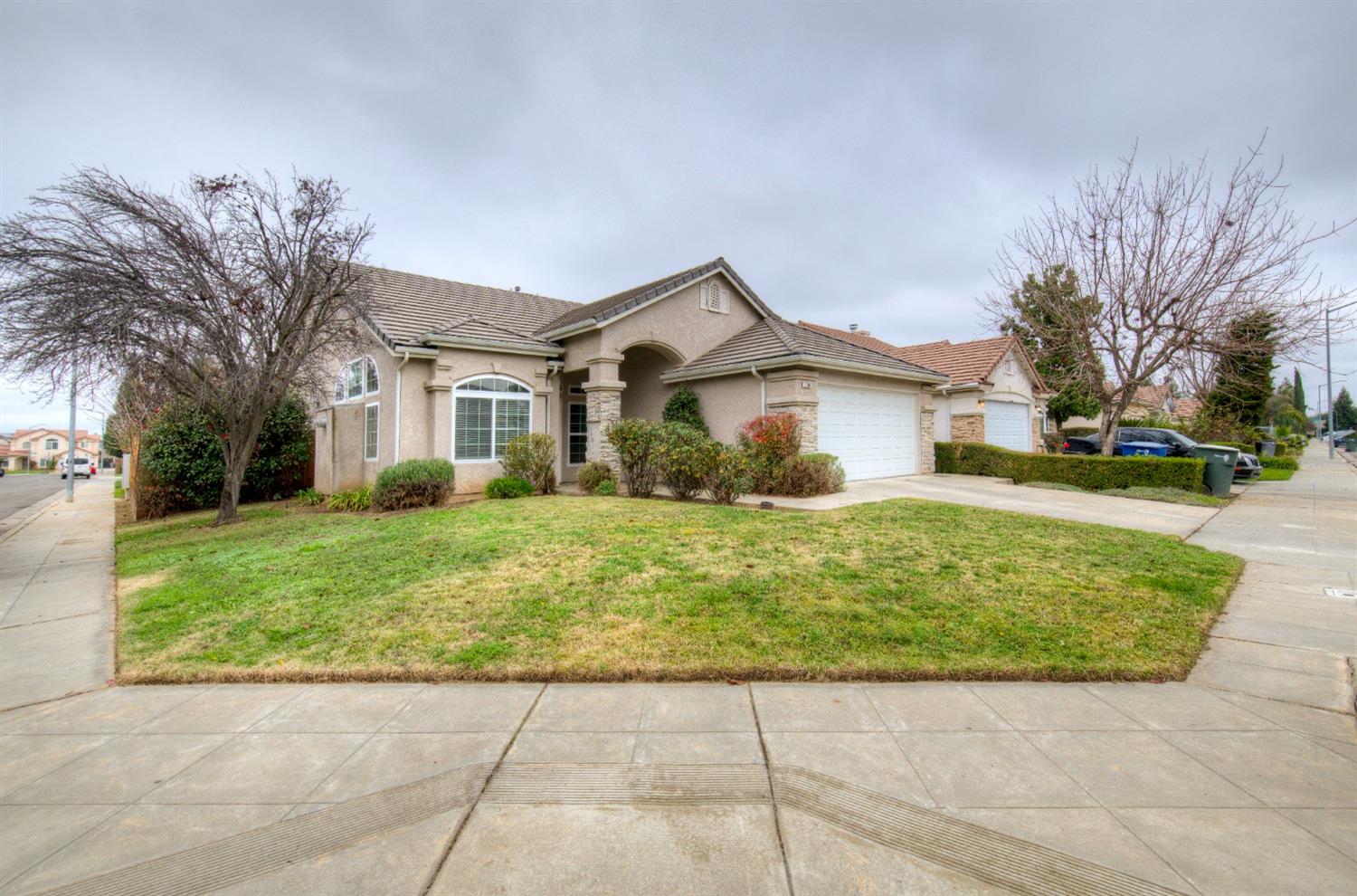 a front view of a house with a garden