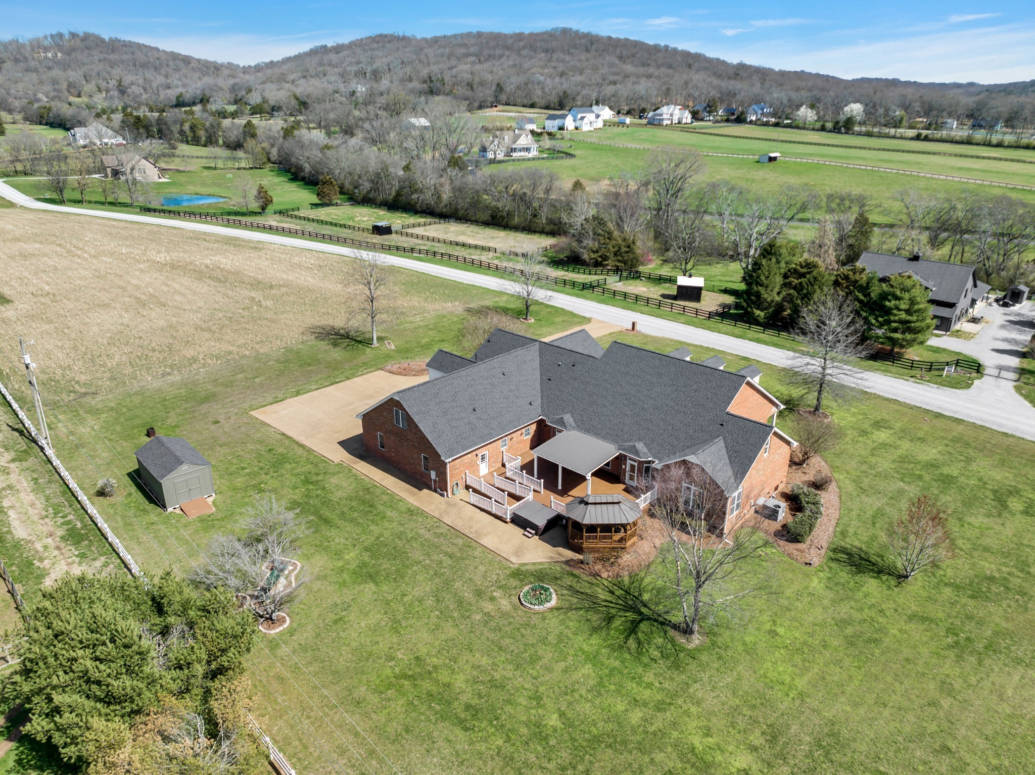 an aerial view of a house with a garden and lake view