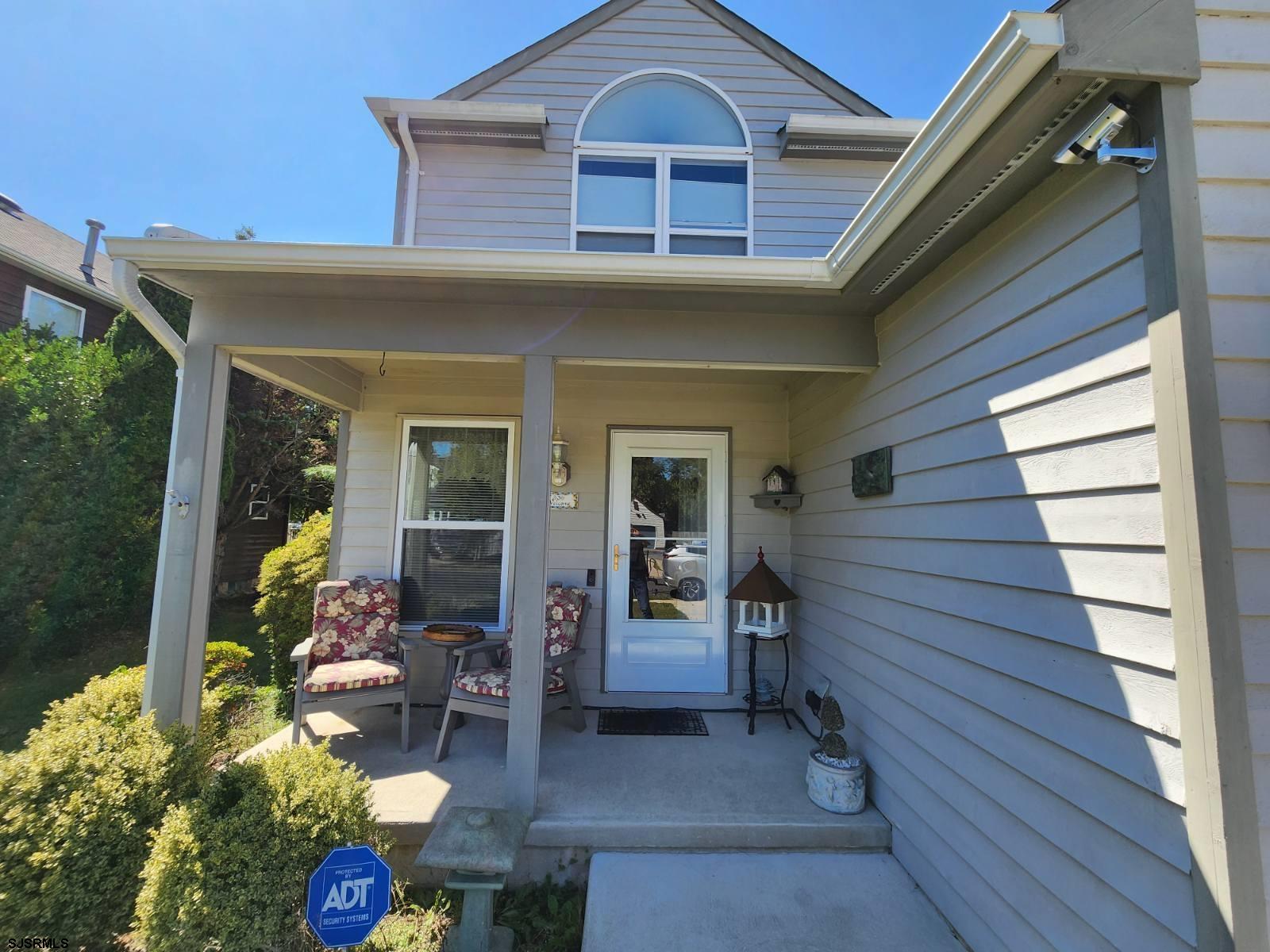 a front view of a house with outdoor seating