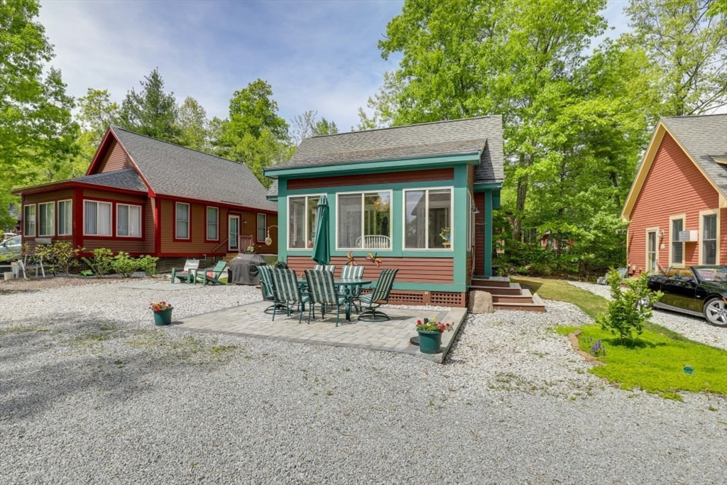 a view of a house with backyard and sitting area