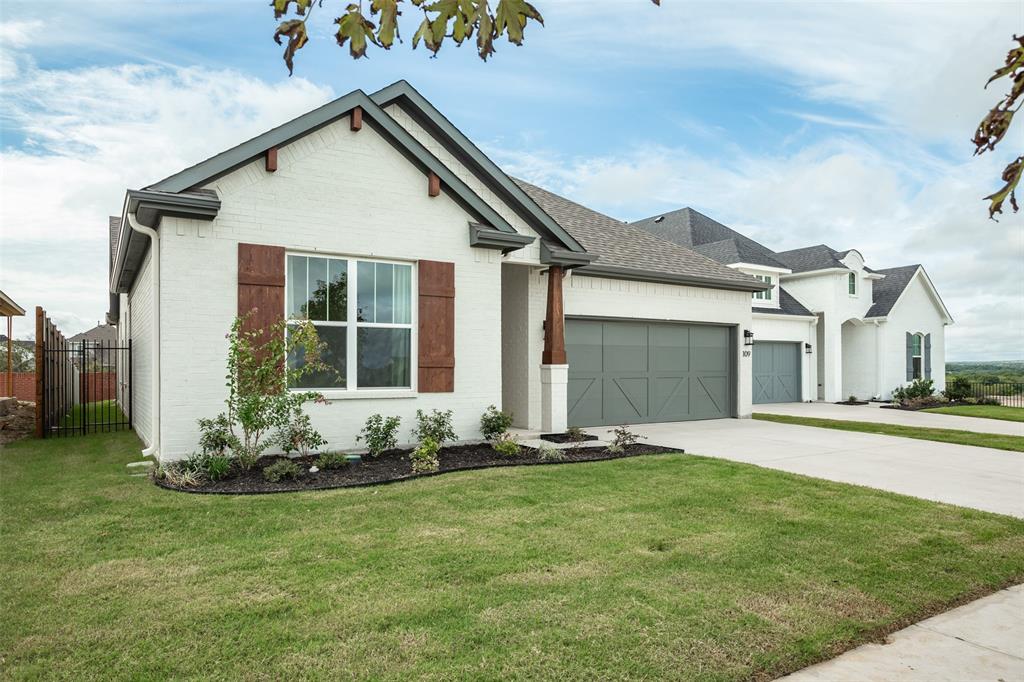 a front view of a house with a garden and yard