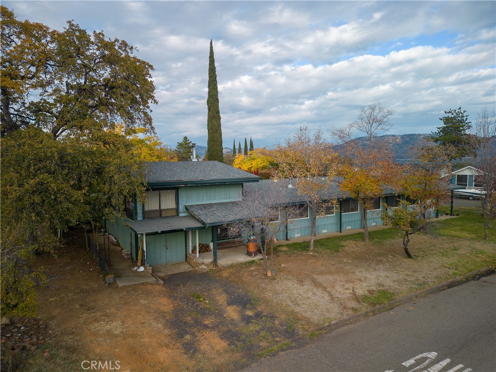 a view of a house with a yard and sitting area