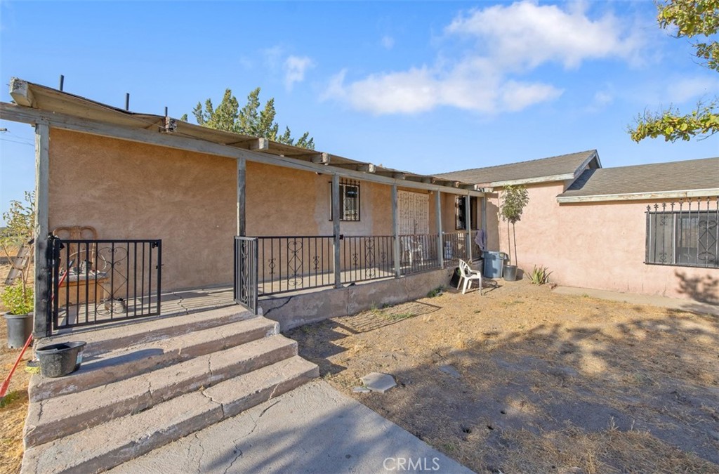 a view of a house with a wooden fence