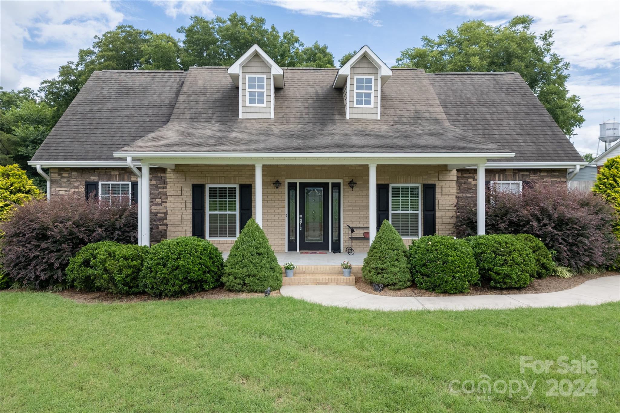 a front view of house with yard and green space