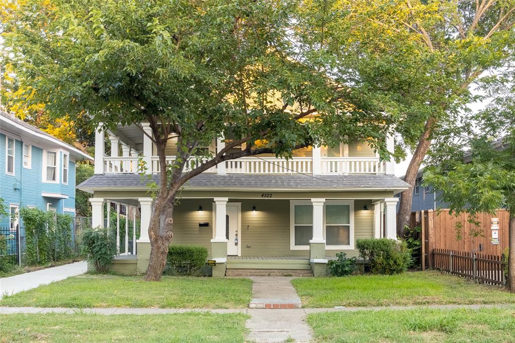 a front view of a brick house with a yard