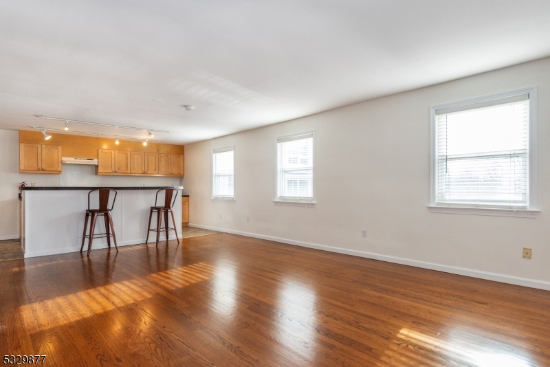 a view of a livingroom with furniture wooden floor and window