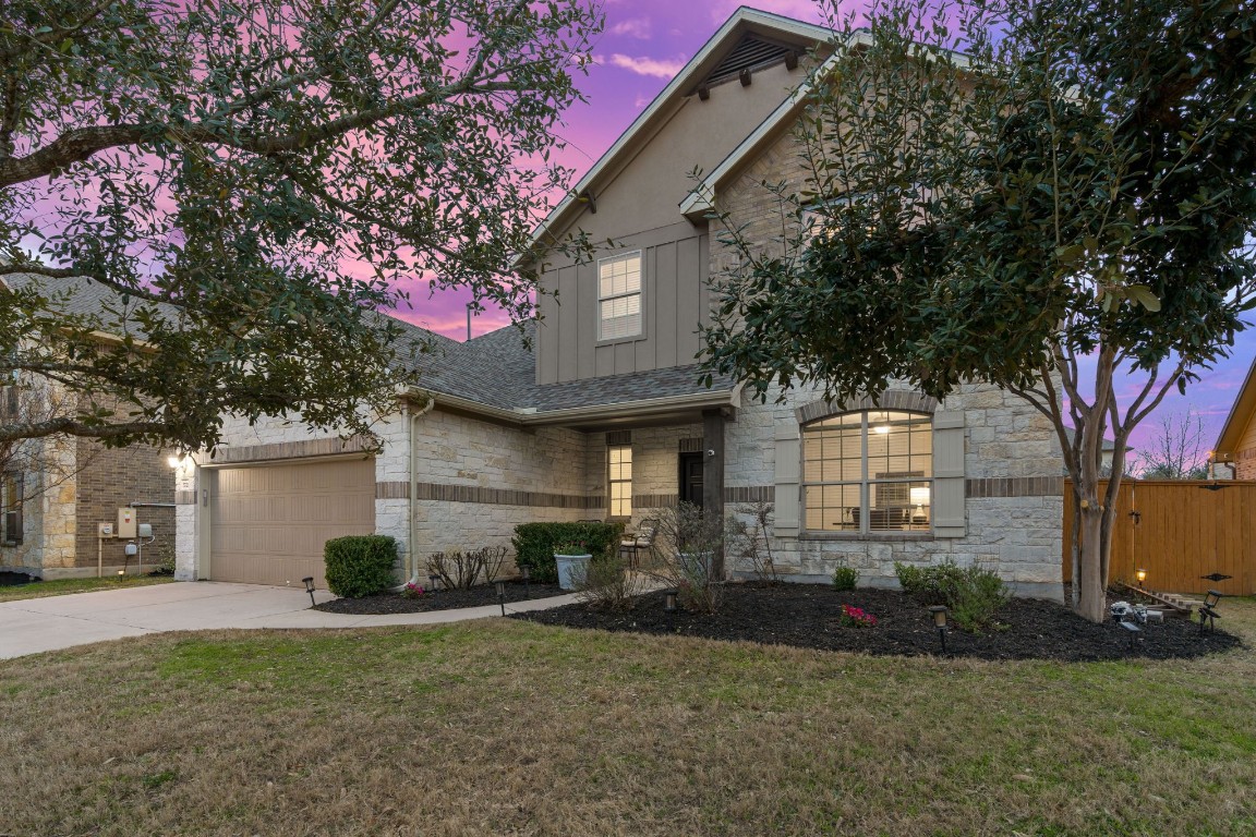 a front view of a house with a yard and garage