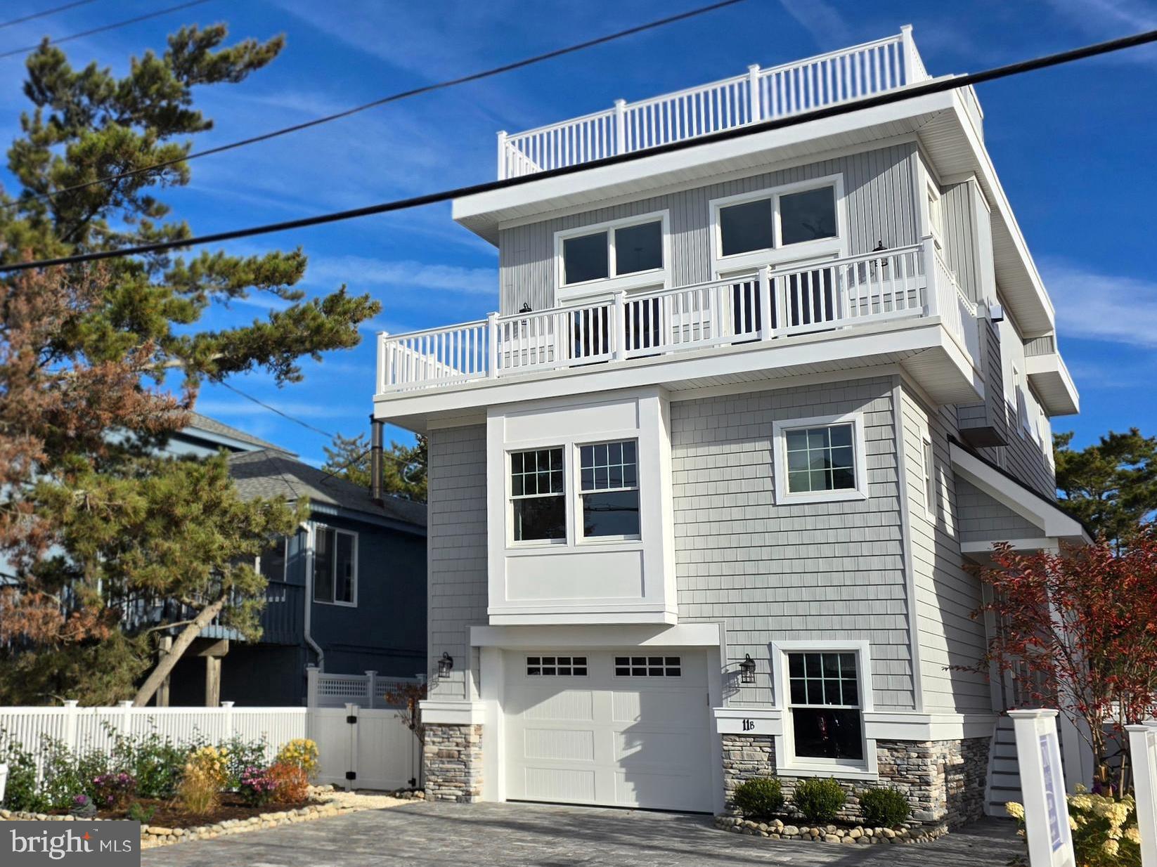 a front view of a house with a tree