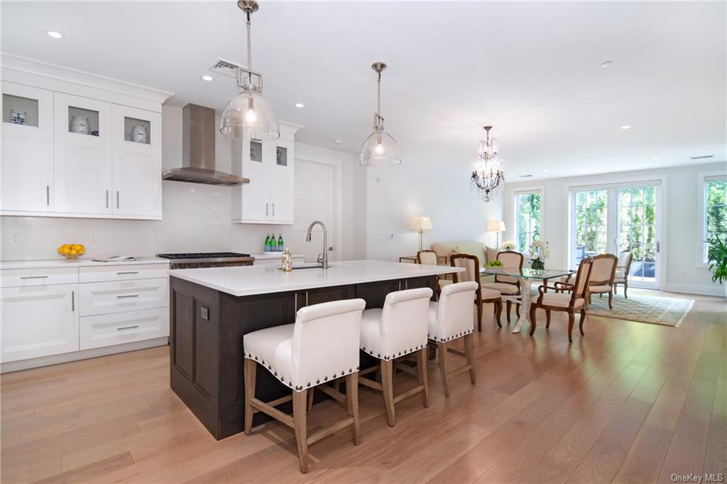 a large kitchen with a table and chairs