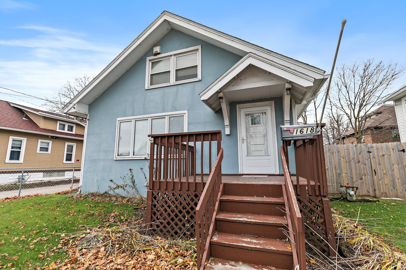 a front view of a house with wooden fence