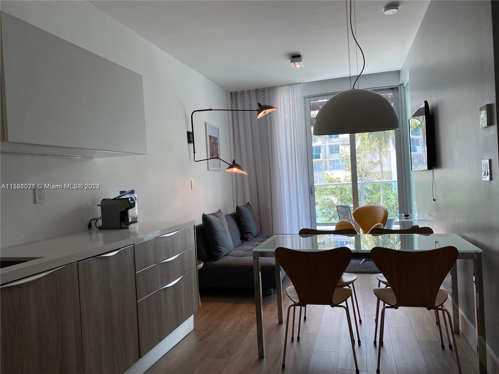 a dining room with furniture and window