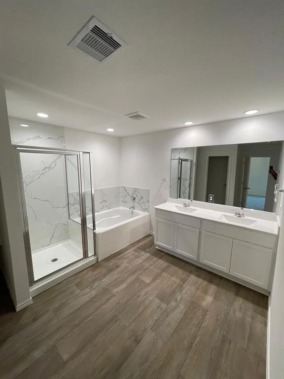 a bathroom with a tub a sink and mirror