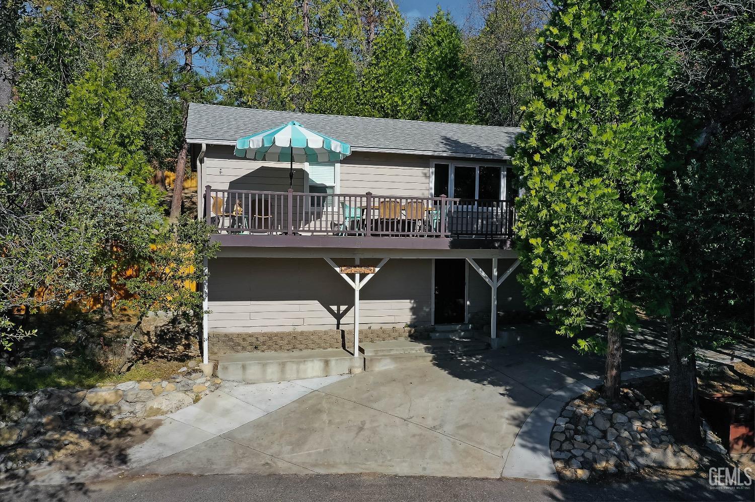 an aerial view of a house with large trees