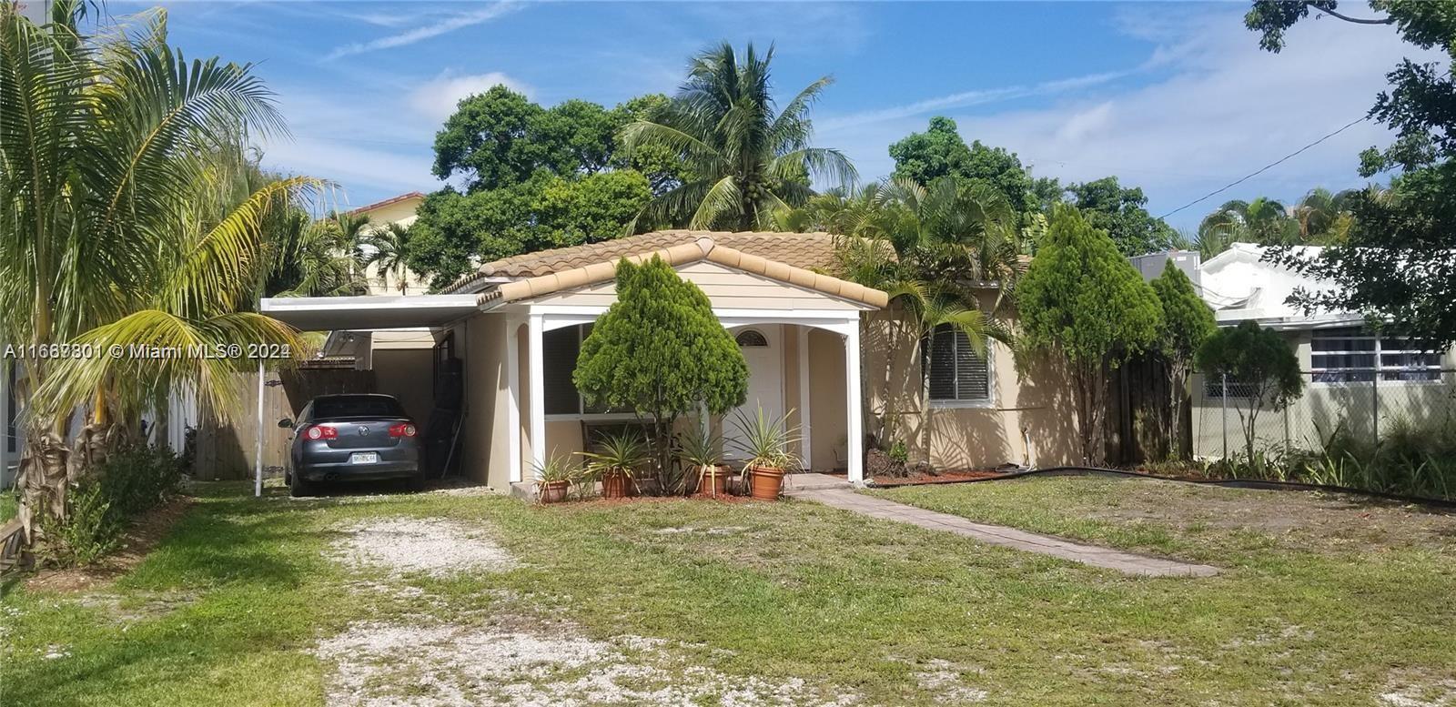 a view of a house with a small yard and plants