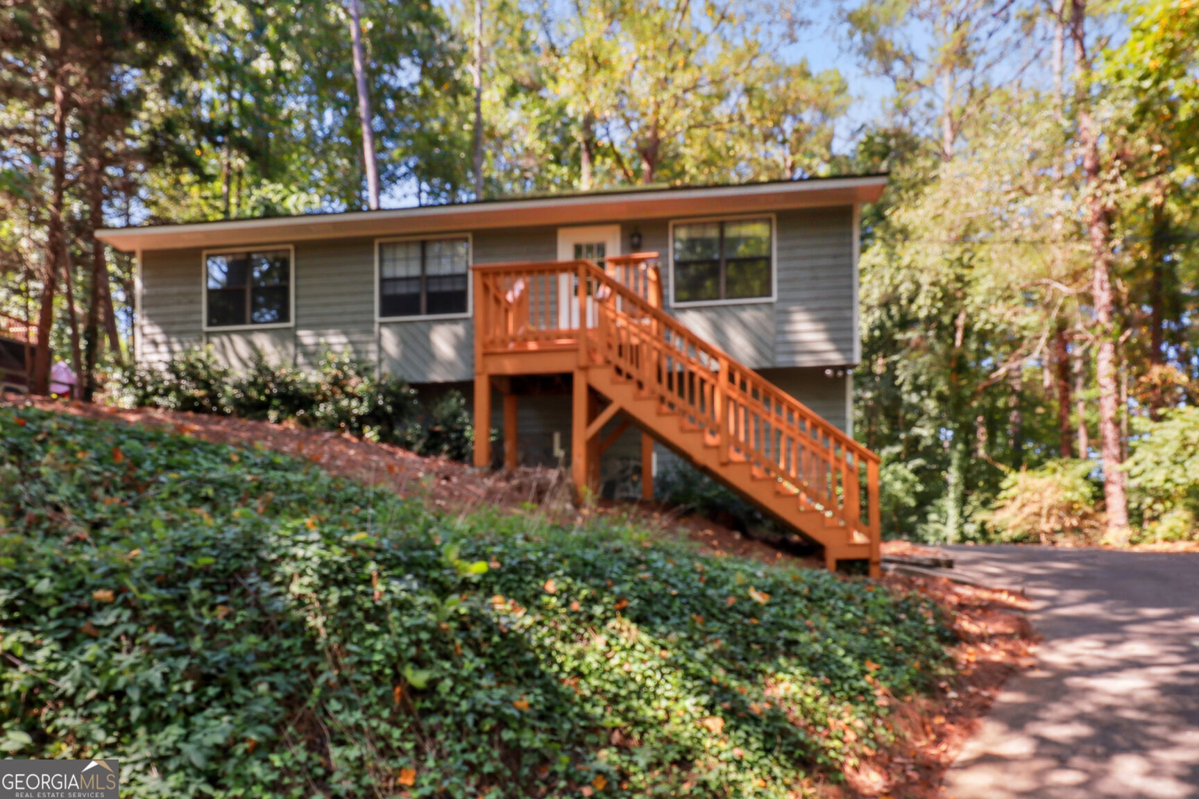 a view of a house with backyard and sitting area