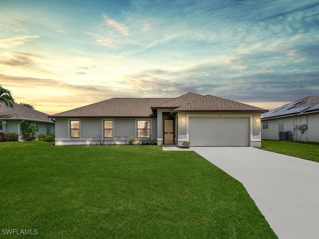 a front view of a house with a garden and yard