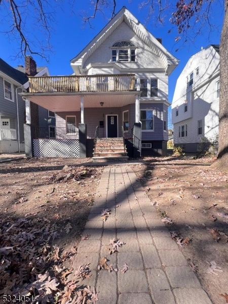 a view of a house with large trees