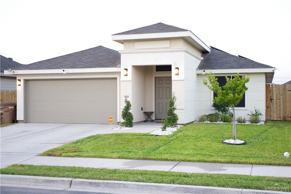 a front view of a house with a yard and garage