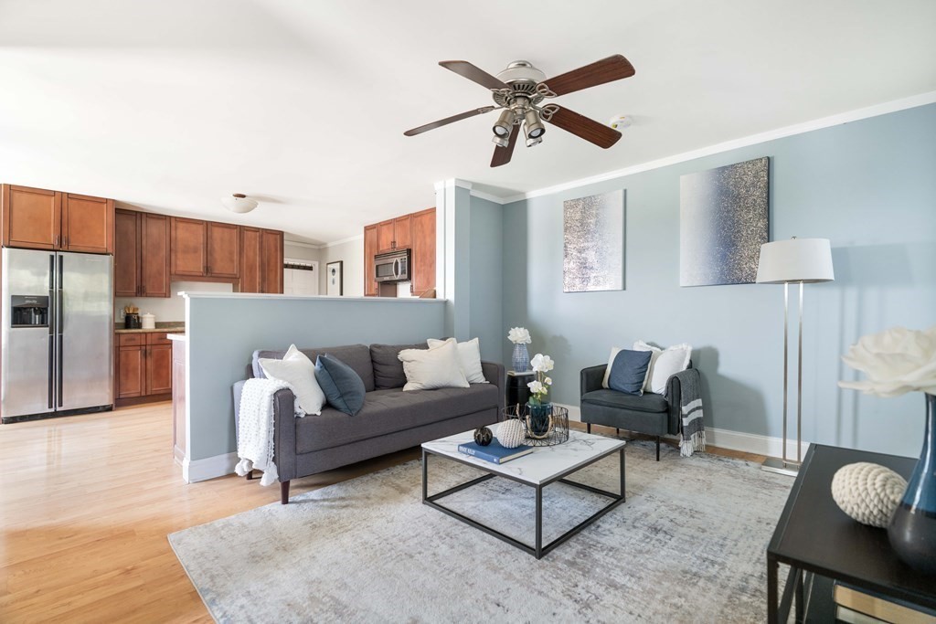 a living room with furniture and a wooden floor