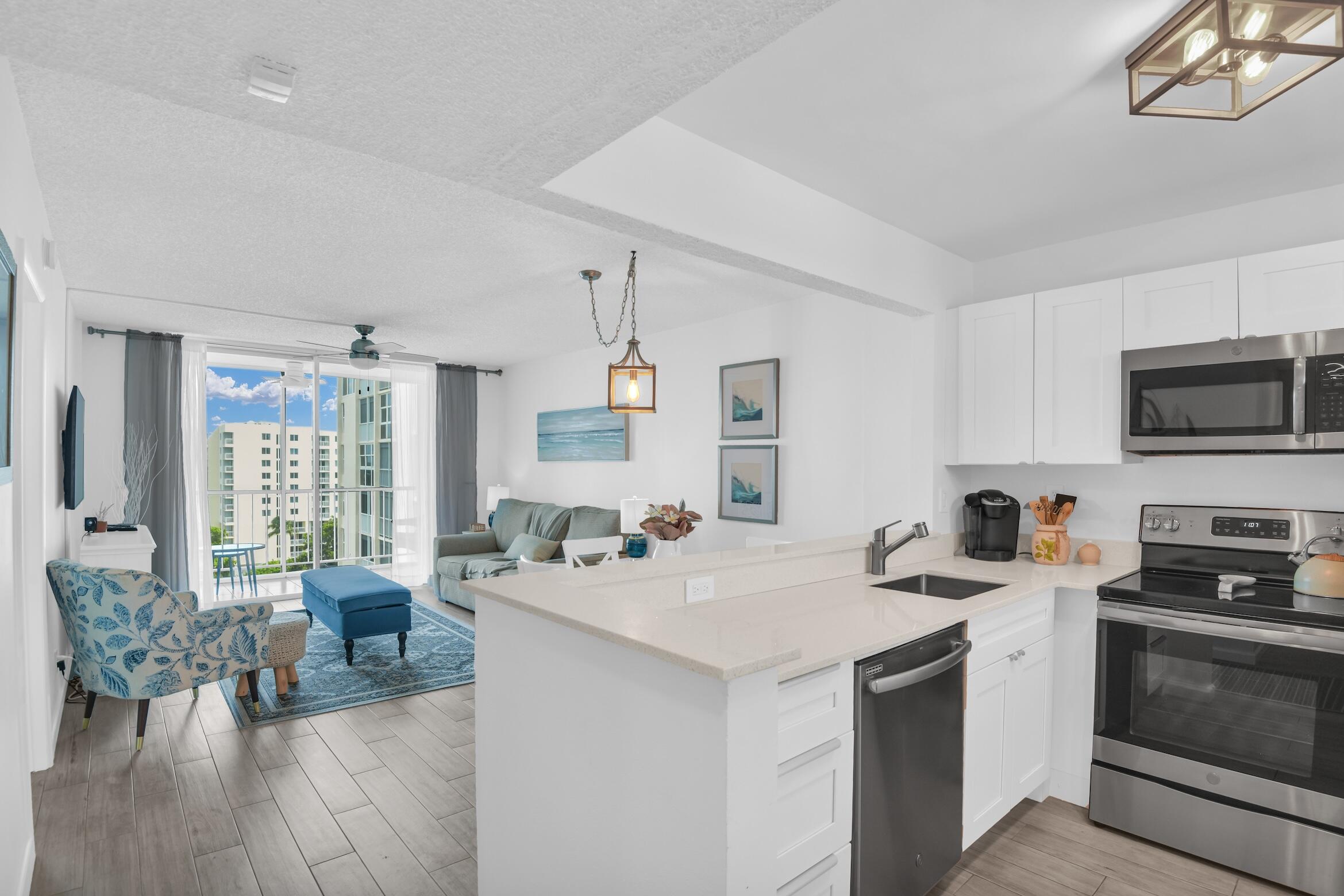 a kitchen with a stove a sink a dining table and chairs