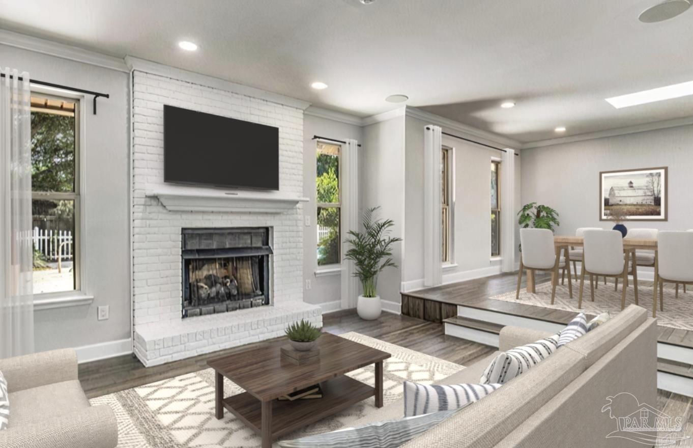 a living room with furniture a flat screen tv and a fireplace