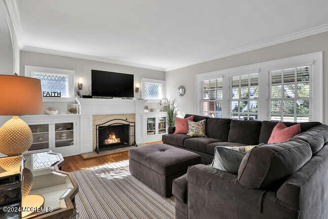 a living room with furniture a flat screen tv and a fireplace