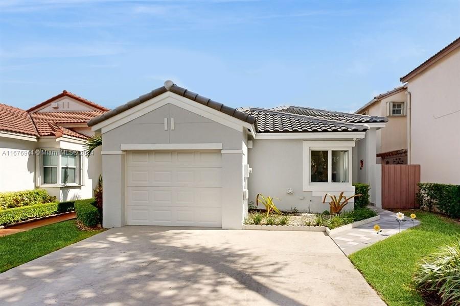 a front view of a house with a yard and garage